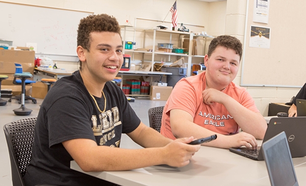 Two male HS students smiling